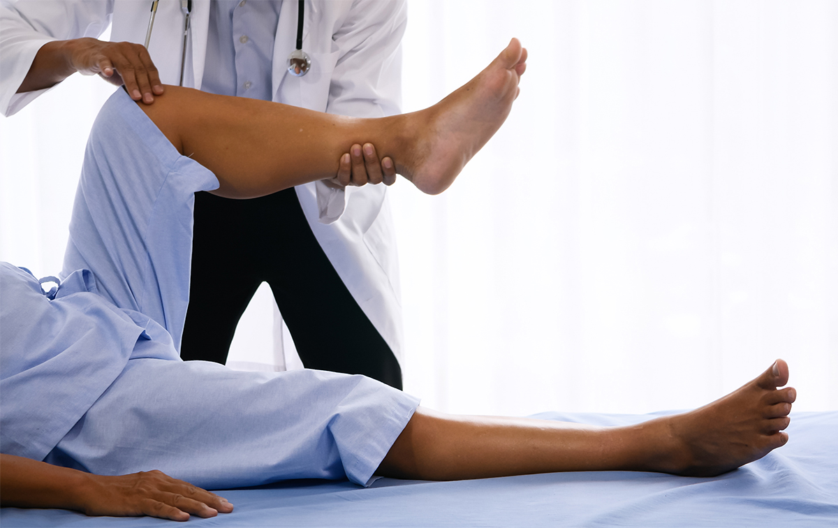 Physical therapist doing physical therapy for adult patient at h